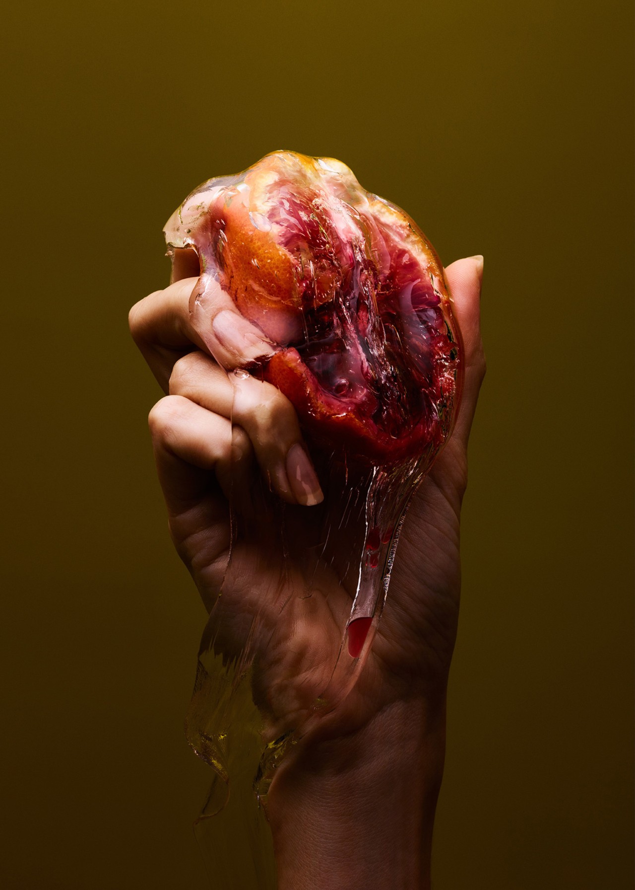 Hand holding blood orange still life by Nicholas Alan Cope