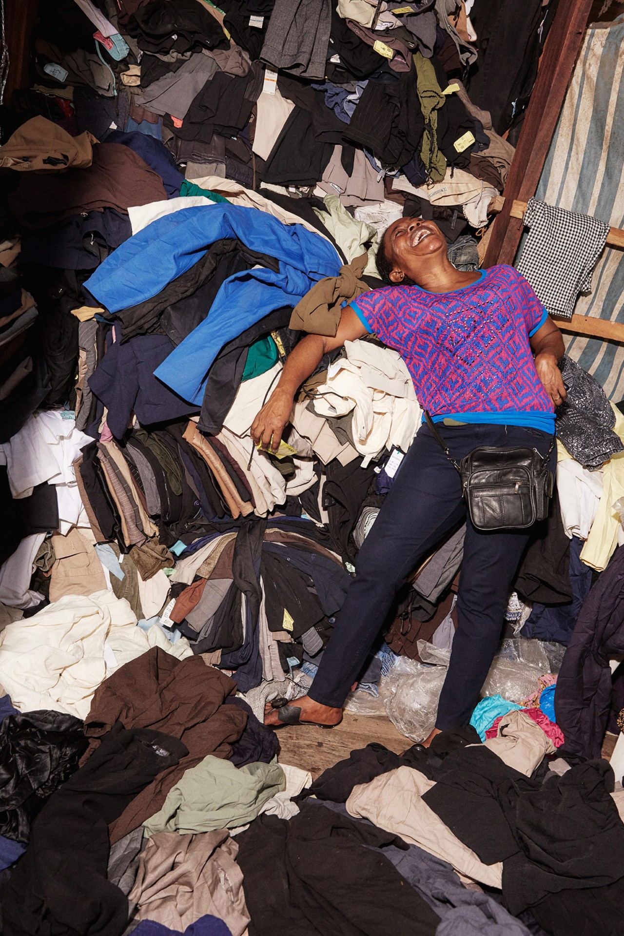 A retailer laughing in Kantamanto Market in Accra Ghana by Charlie Engman
