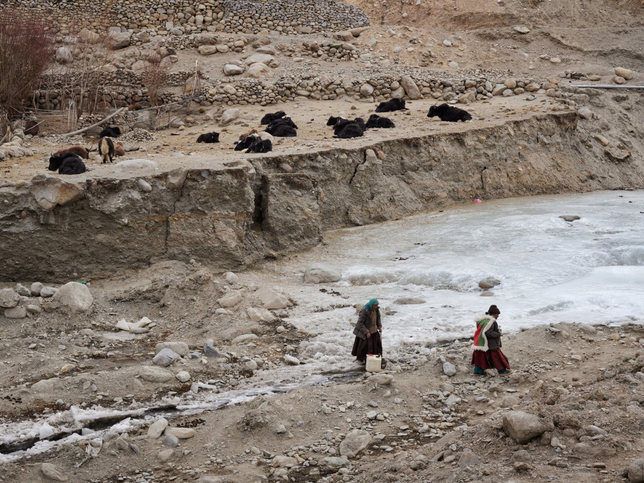 Villagers cross a river in Ladakh India by Greg White