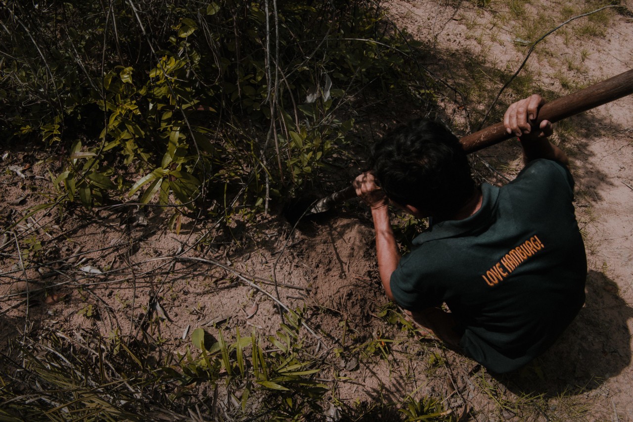 Chem Wai digs a hole with a spade while searching for tarantulas and scorpions in Siem Reap Cambodia by Rishabh Malik