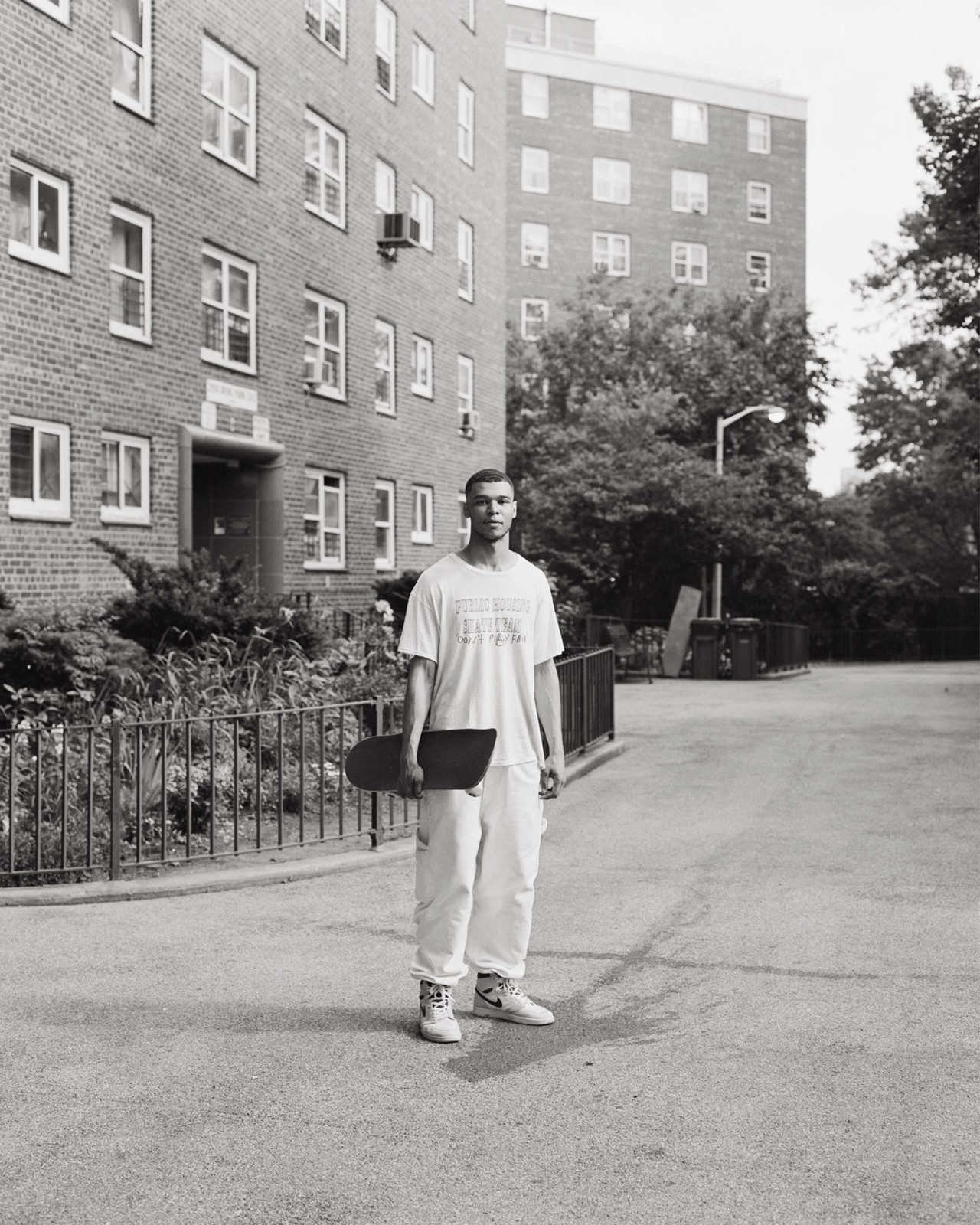 Portrait of man with skateboard in New York City by Ben Grieme