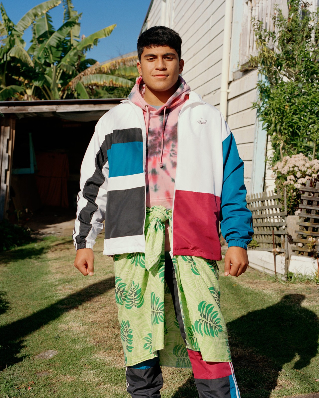 A teenage boy wears a mix of traditional and international clothing in Auckland New Zealand by Derek Henderson