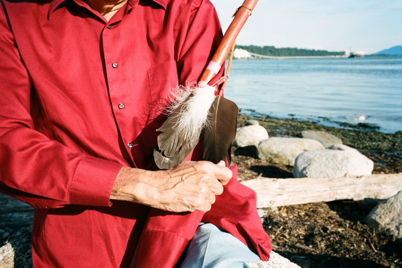 Lumni Nation tribal chief Bill James holding walking stick with eagle feather by Max Farago