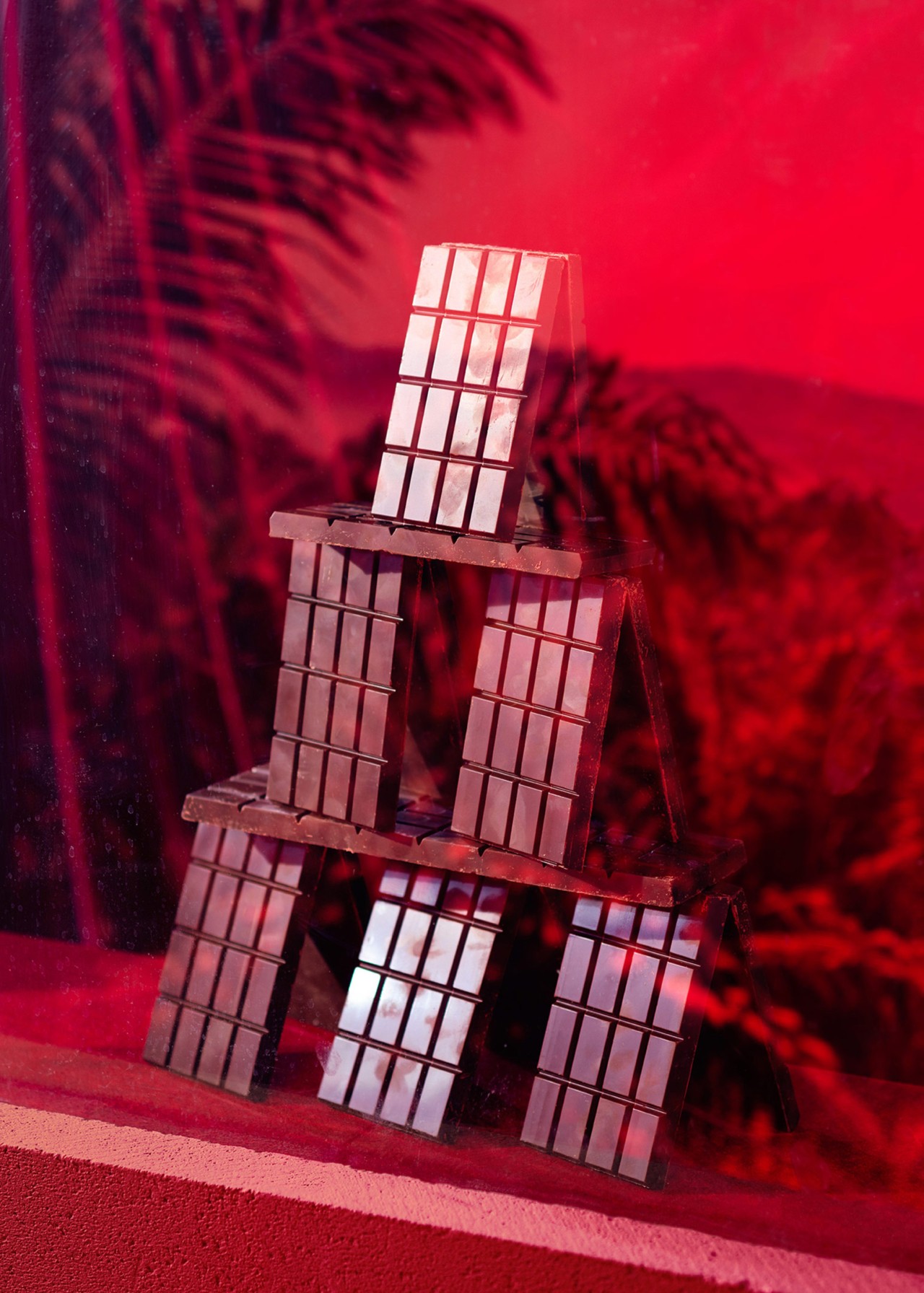 Stacked chocolate bars in store window representing palm oil by Thomas Albdorf