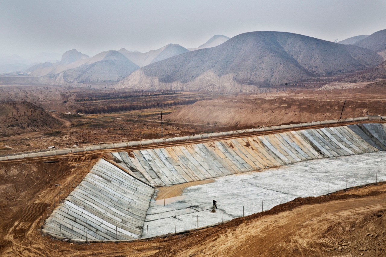 Excavating sand to build a new city in the desert in Gansu China by Sim Chi Yin