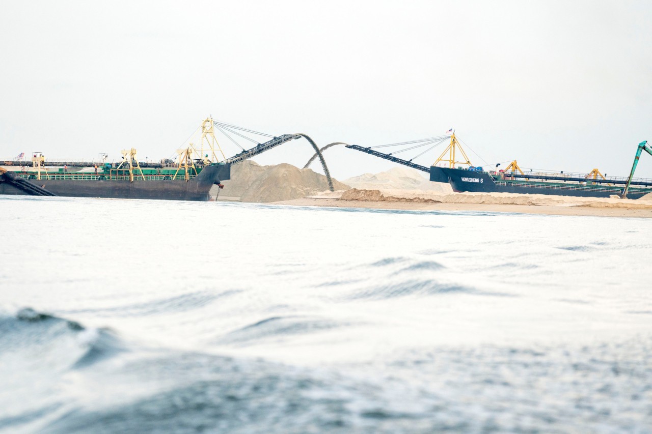 Two ships depositing sand in Singapore by Sim Chi Yin