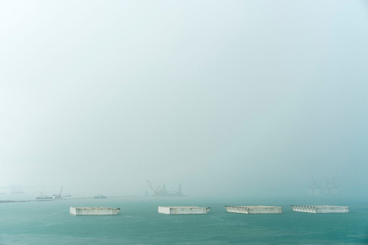 Four retaining structures off the coast of Singapore used in a land reclamation project by Sim Chi Yin