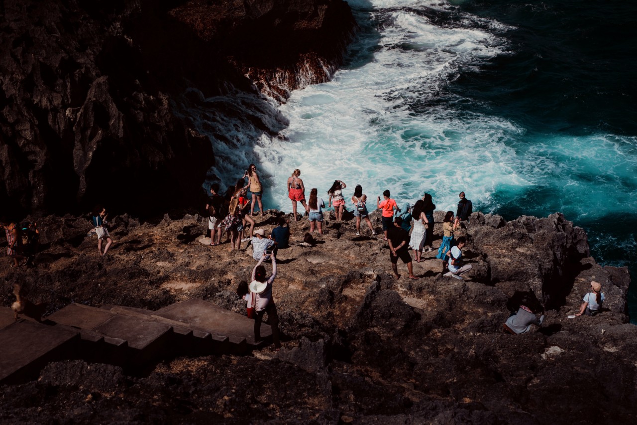 Tourists on cliff in Nusa Penuda Indonesia by Rishabh Malik