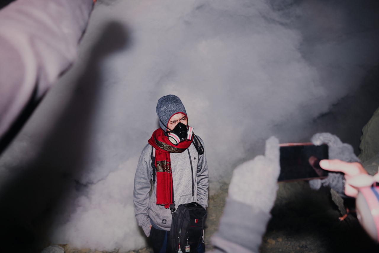 Tourist with mask at Mt Ijen volcano in Indonesia by Rishabh Malik
