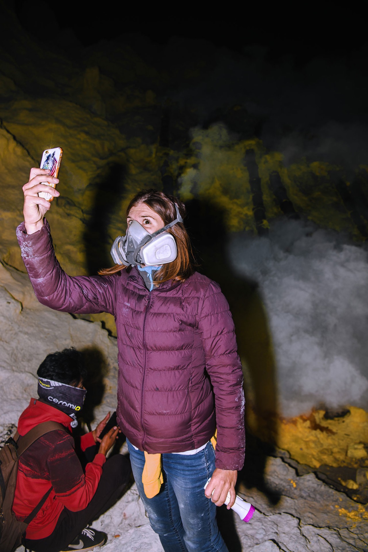 Tourist taking selfie with mask at Mt Ijen volcano in Indonesia by Rishabh Malik