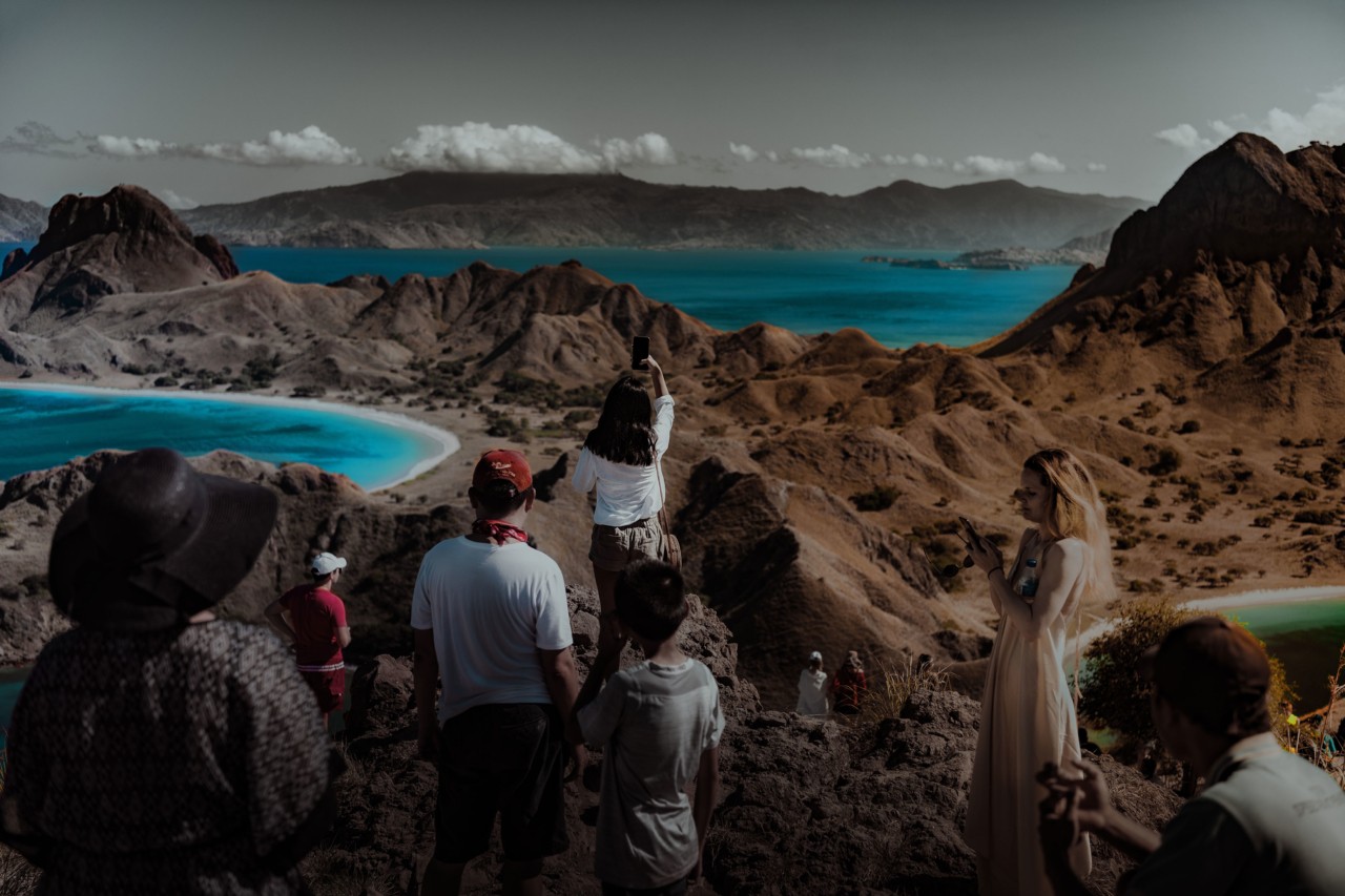Tourists taking selfies on cliff in Nusa Penuda Indonesia by Rishabh Malik