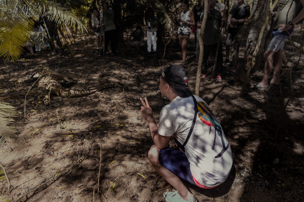 Tourist with komodo dragon on Komodo Island Indonesia by Rishabh Malik