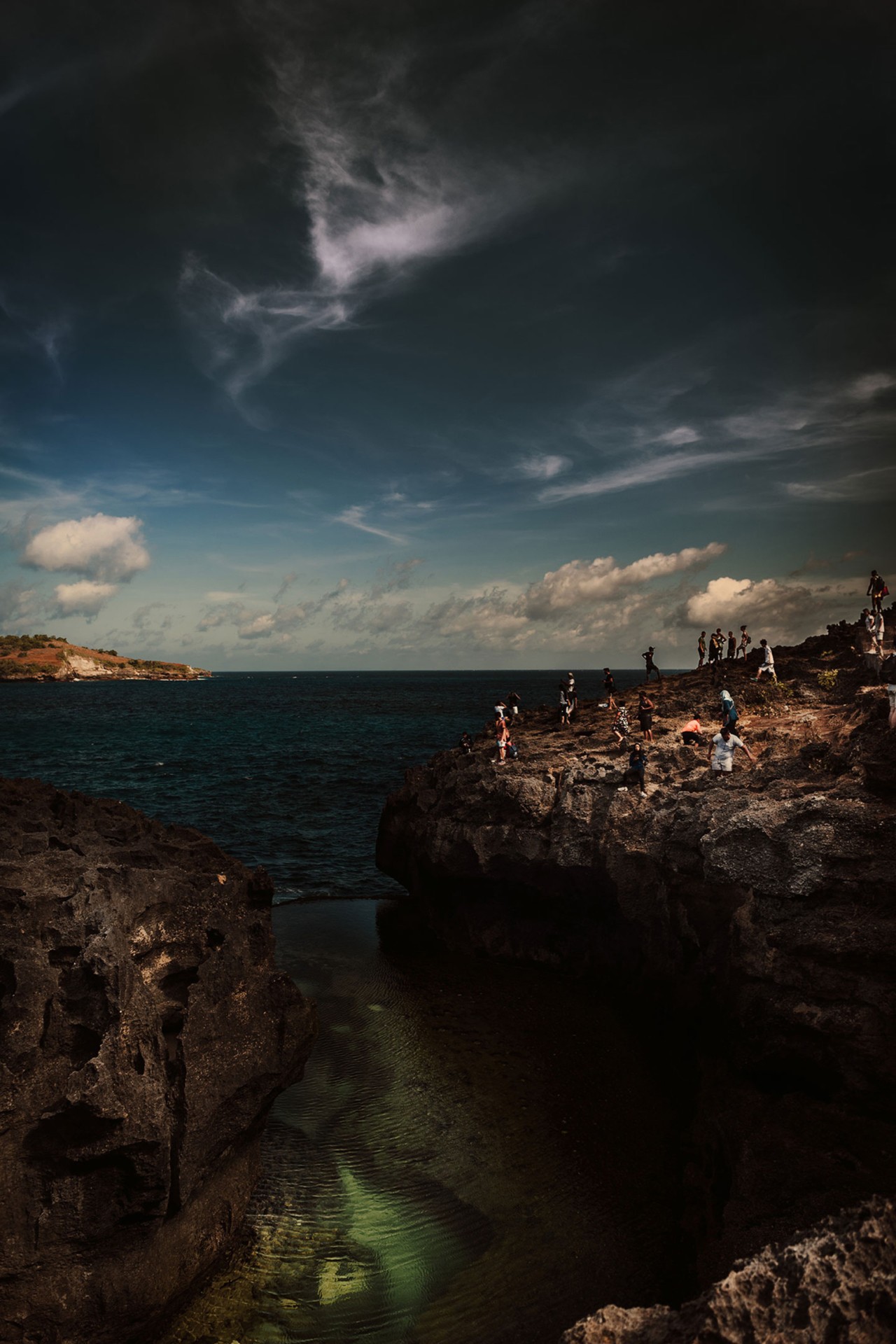 Tourists on cliff in Nusa Penuda Indonesia by Rishabh Malik