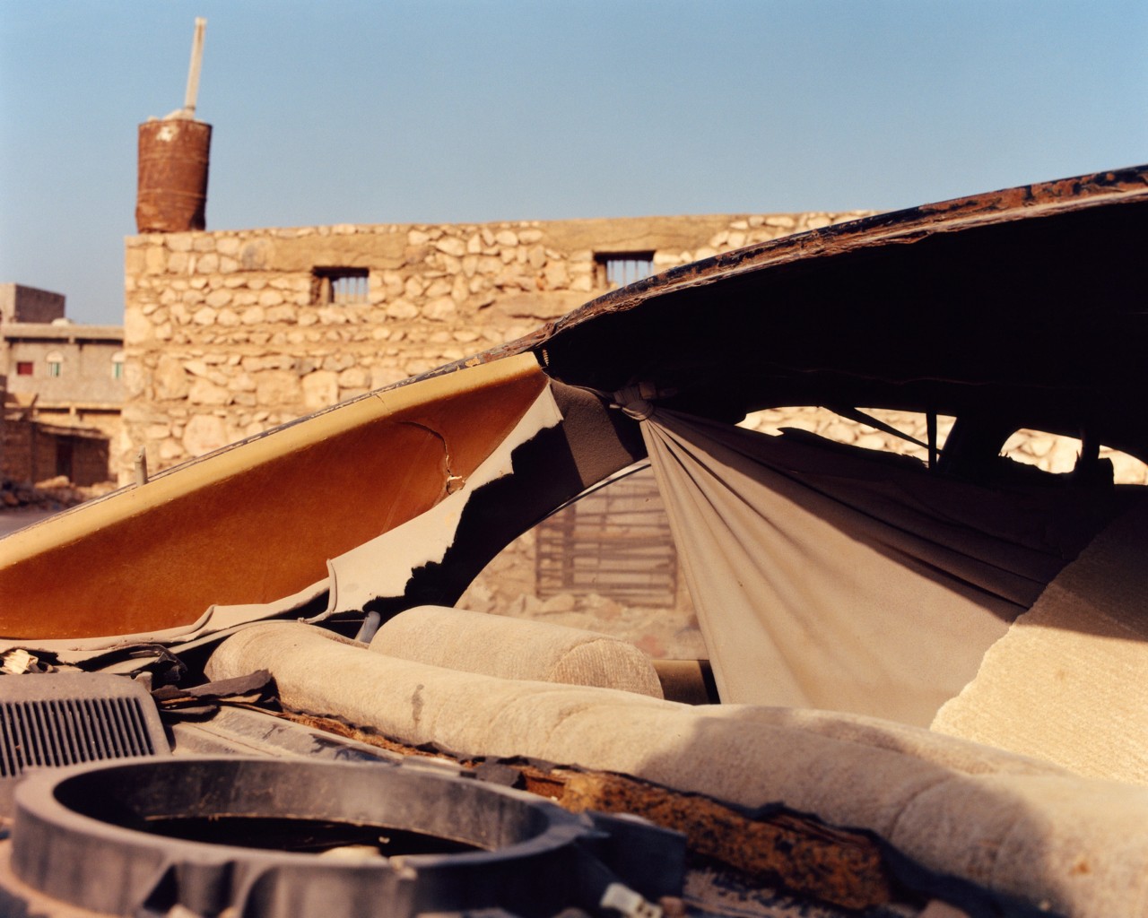 Exposed back of a car in a auto repair shop in Socotra Yemen by Jamie Hawkesworth