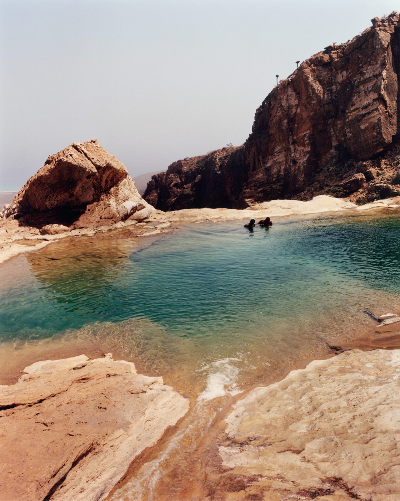 A natural pool of water on a cliffside in Socotra Yemen by Jamie Hawkesworth