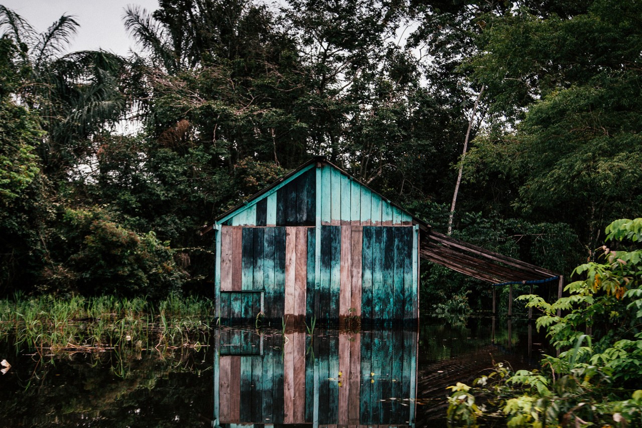 Shed on Amazon river by Liliana Merizalde
