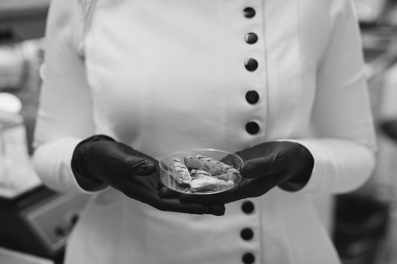 Woman scientist holding petri dish with specimen by Rich Gilligan