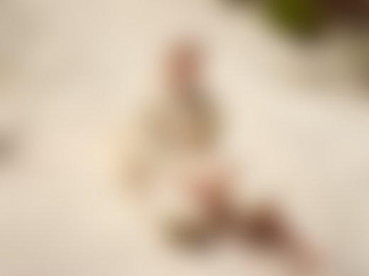 Child sitting in sand by Pieter Hugo