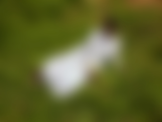 Child laying down in grass by Pieter Hugo