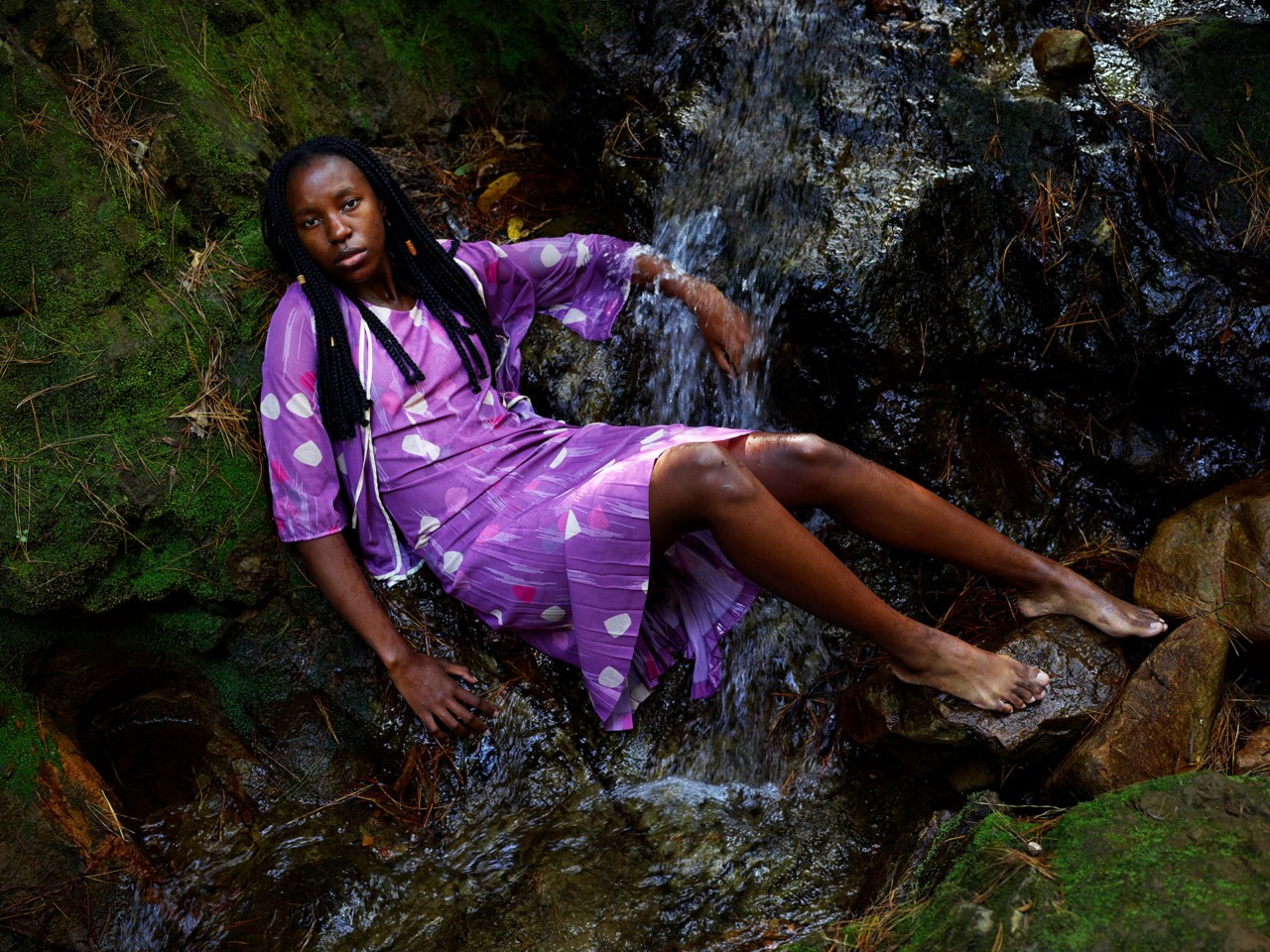 Child laying down in forest by Pieter Hugo
