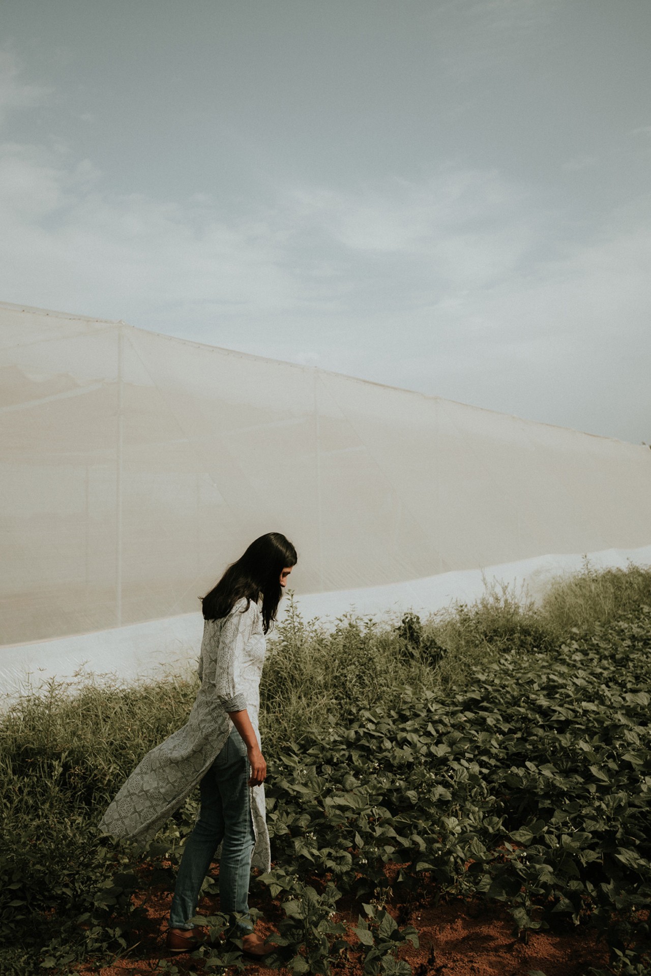 Man walking in field by Rishabh Malik