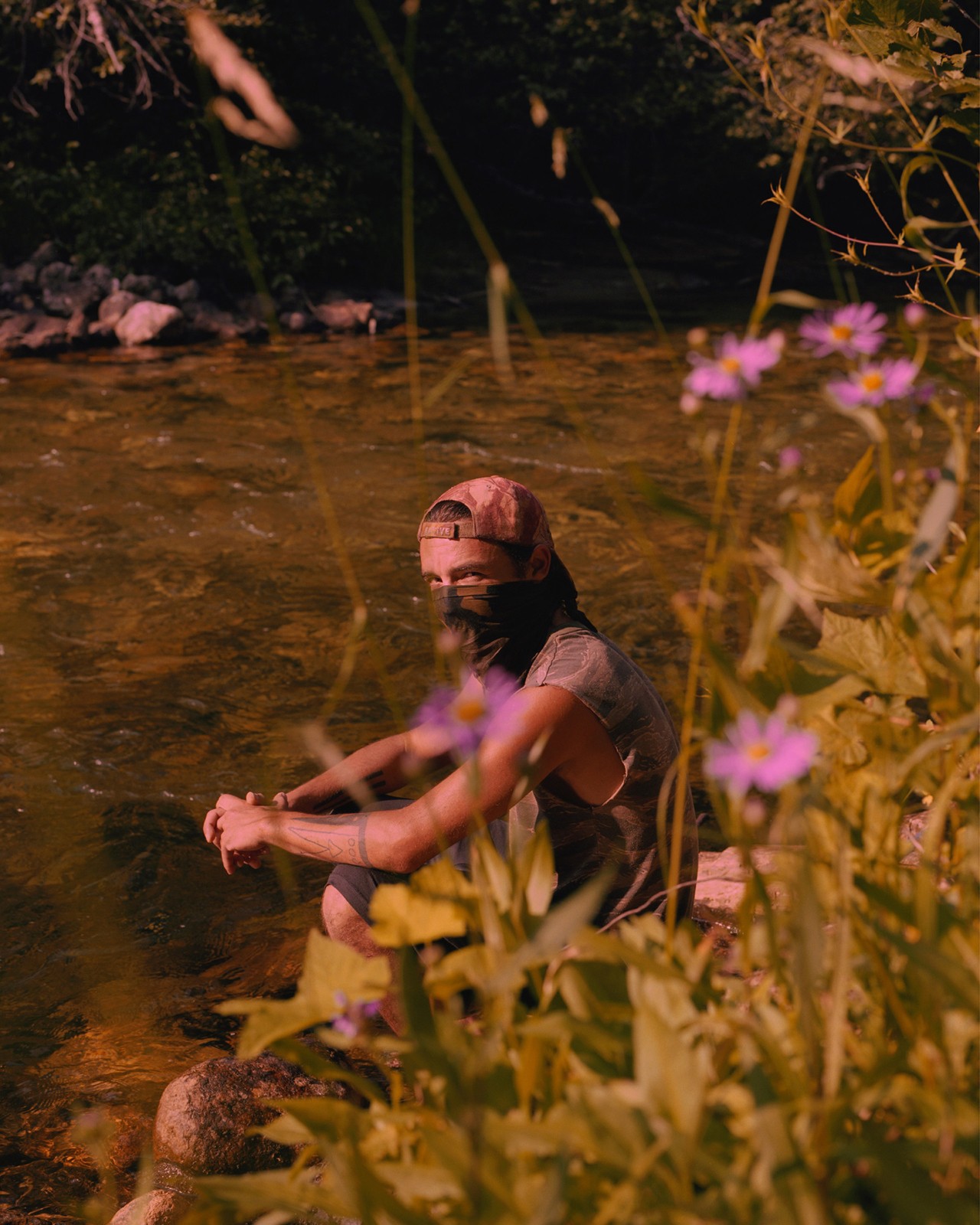 Man on river bank in bandana by Ryan Shorosky