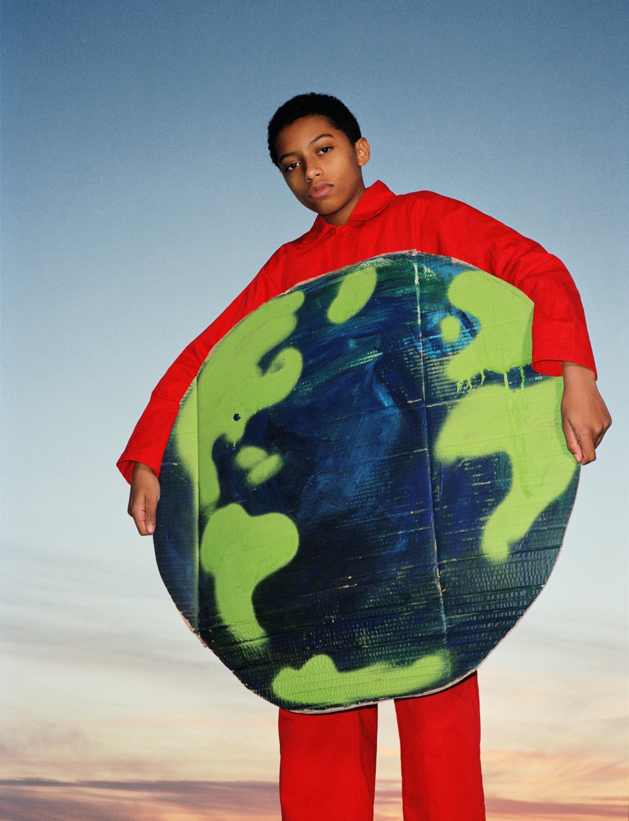 Extinction Rebellion youth protester holding Earth sign by Ben Toms
