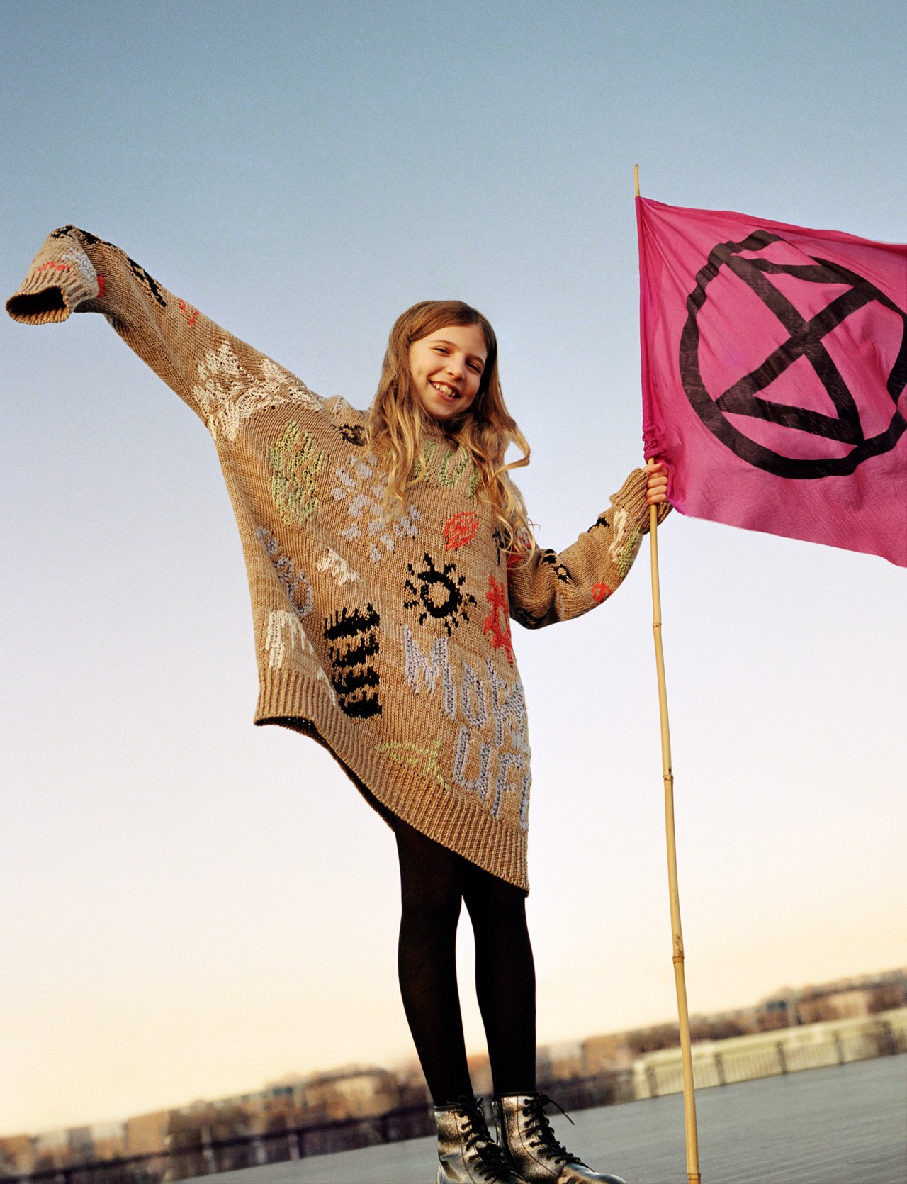 Extinction Rebellion youth protester holding pink flag by Ben Toms