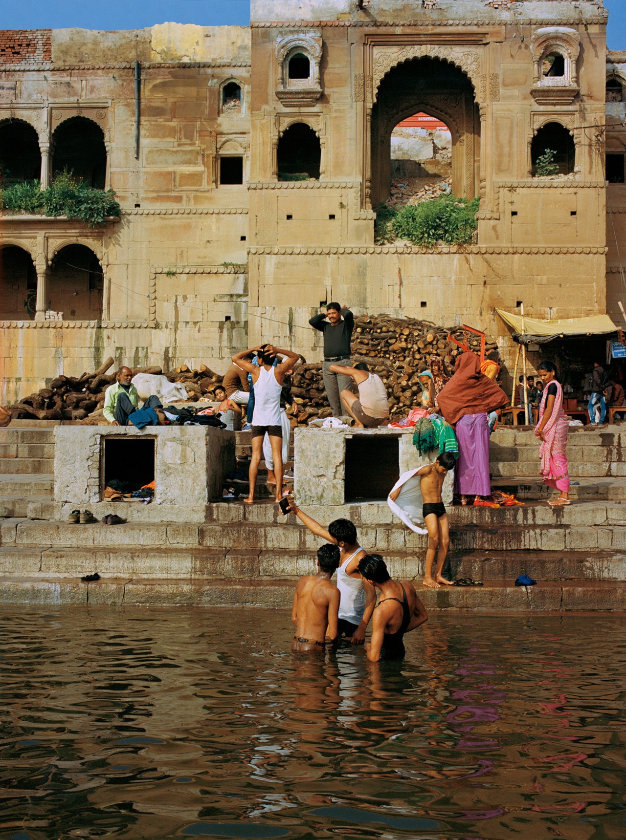 People bathing along the Ganges River in India by Ashish Shah