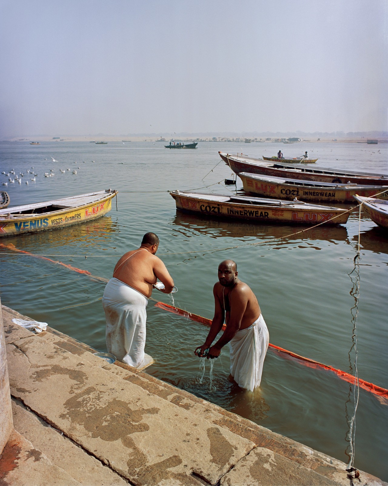 People along the Ganges River in India by Ashish Shah