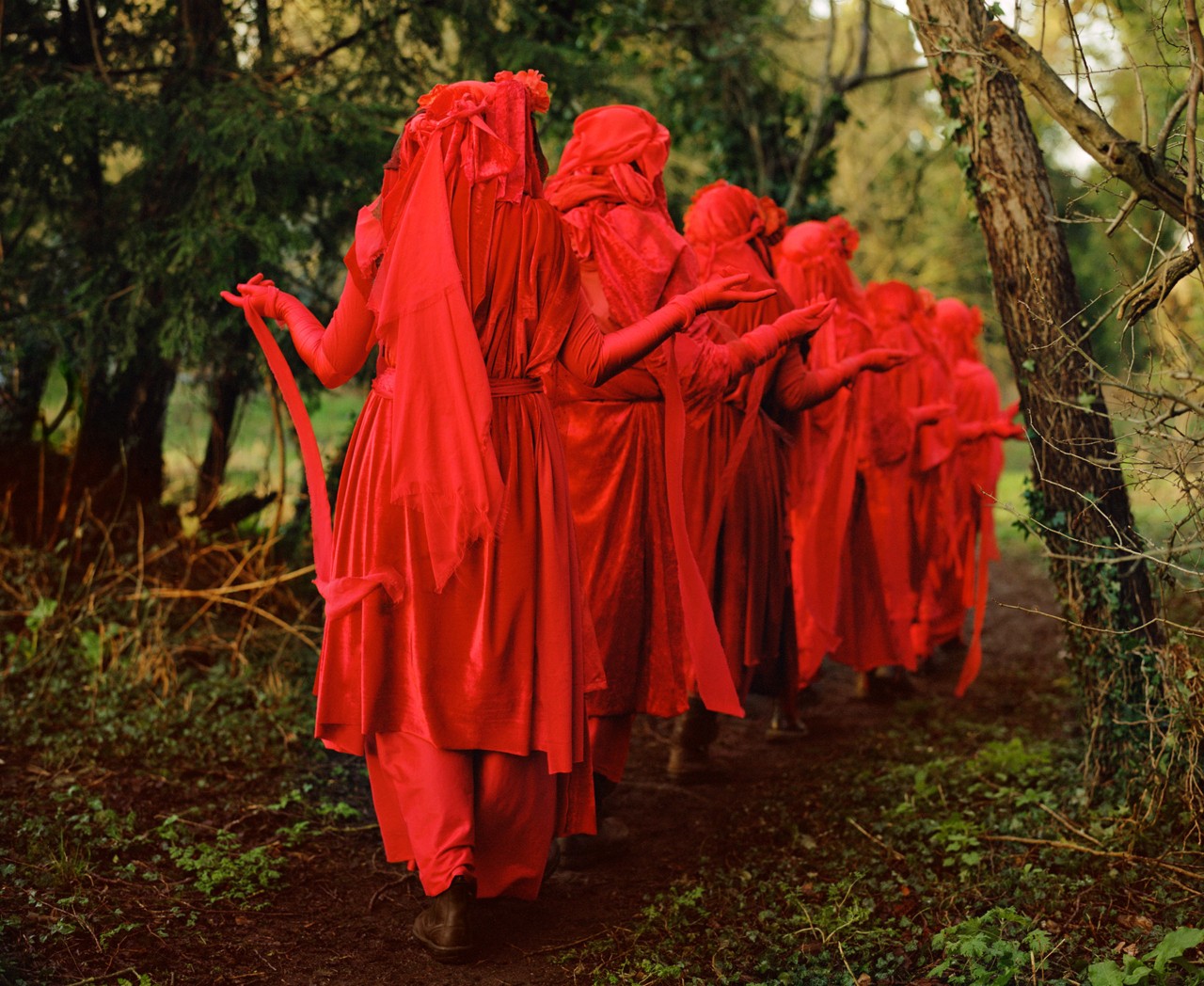 Red Rebel Brigade of Extinction Rebellion in forest by Ben Toms