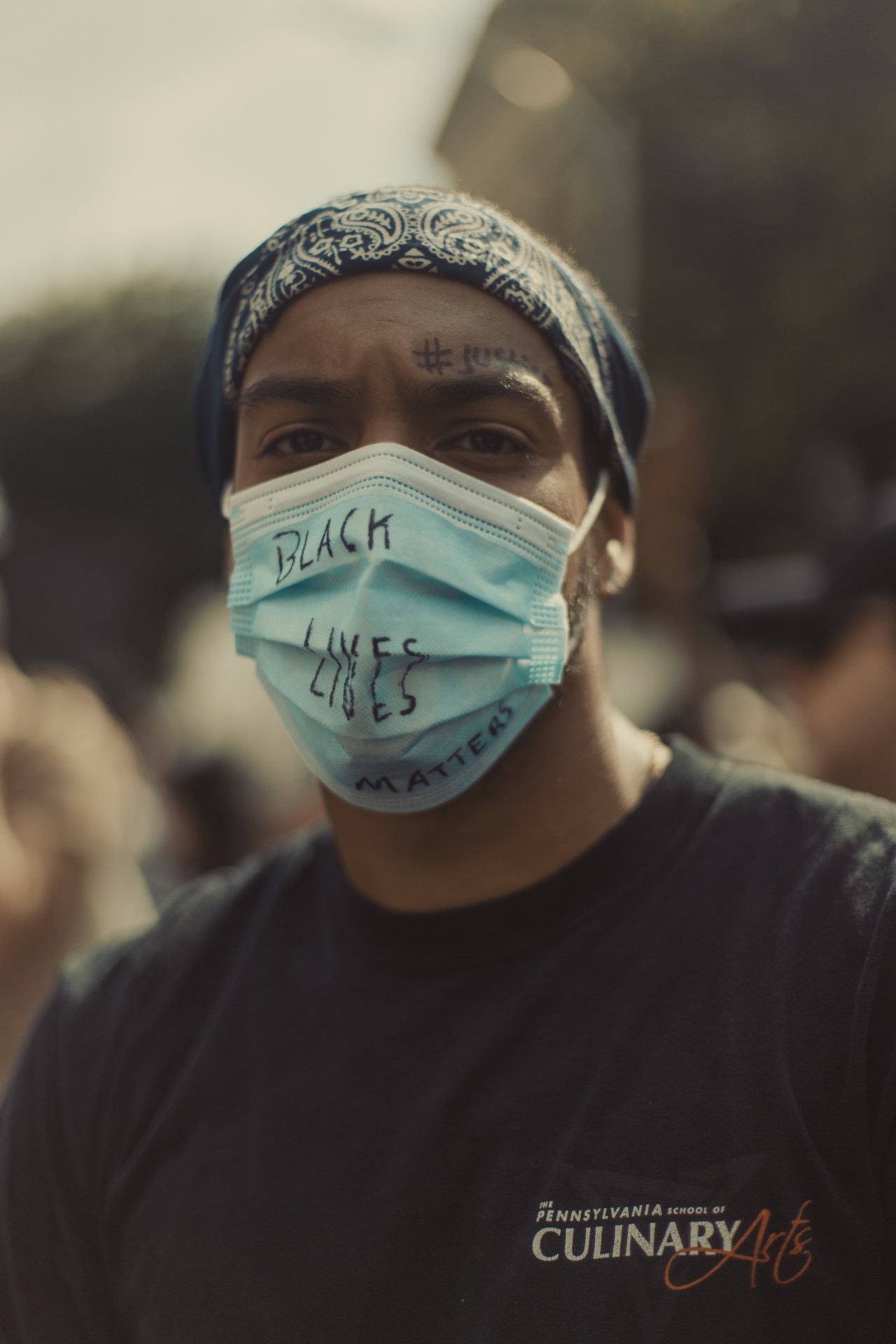 Black Lives Matter protestor wearing COVID face mask by Braylen Dion