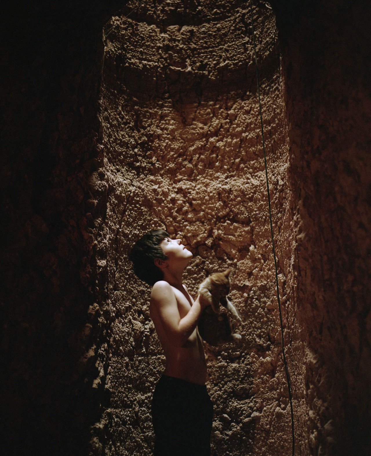 Coober Pedy child holding cat by Alex Lockett