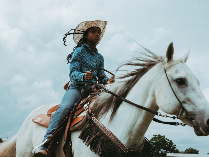 Girl riding horse with Compton Cowboys by Ivan McLellan