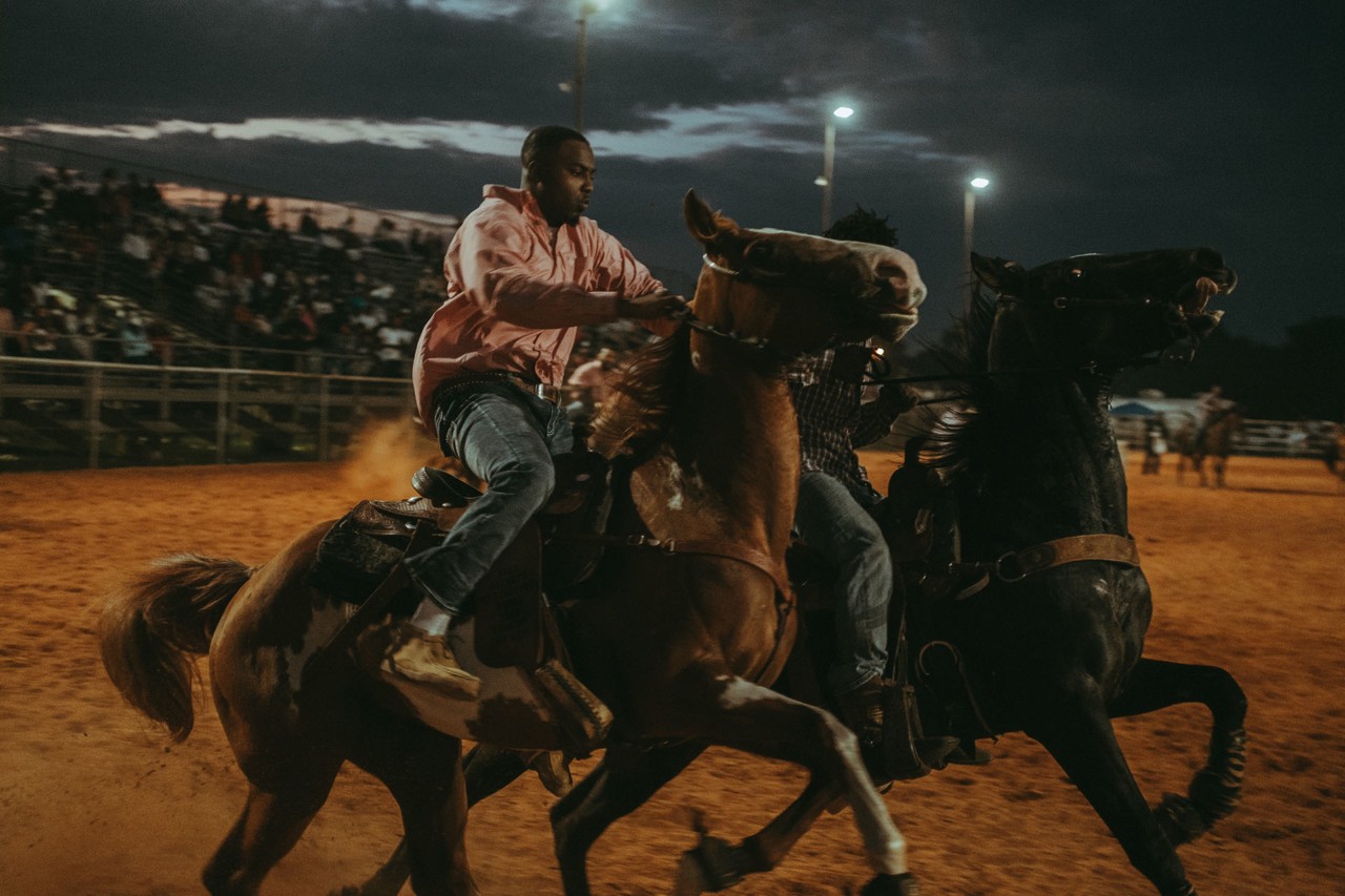 Man riding horse with Compton Cowboys by Ivan McLellan