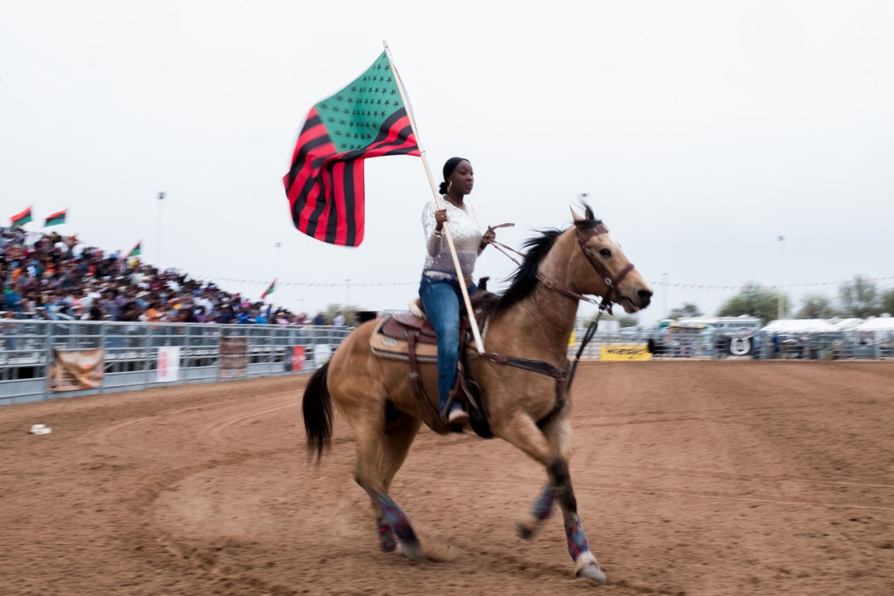 Man riding horse with Compton Cowboys by Ivan McLellan