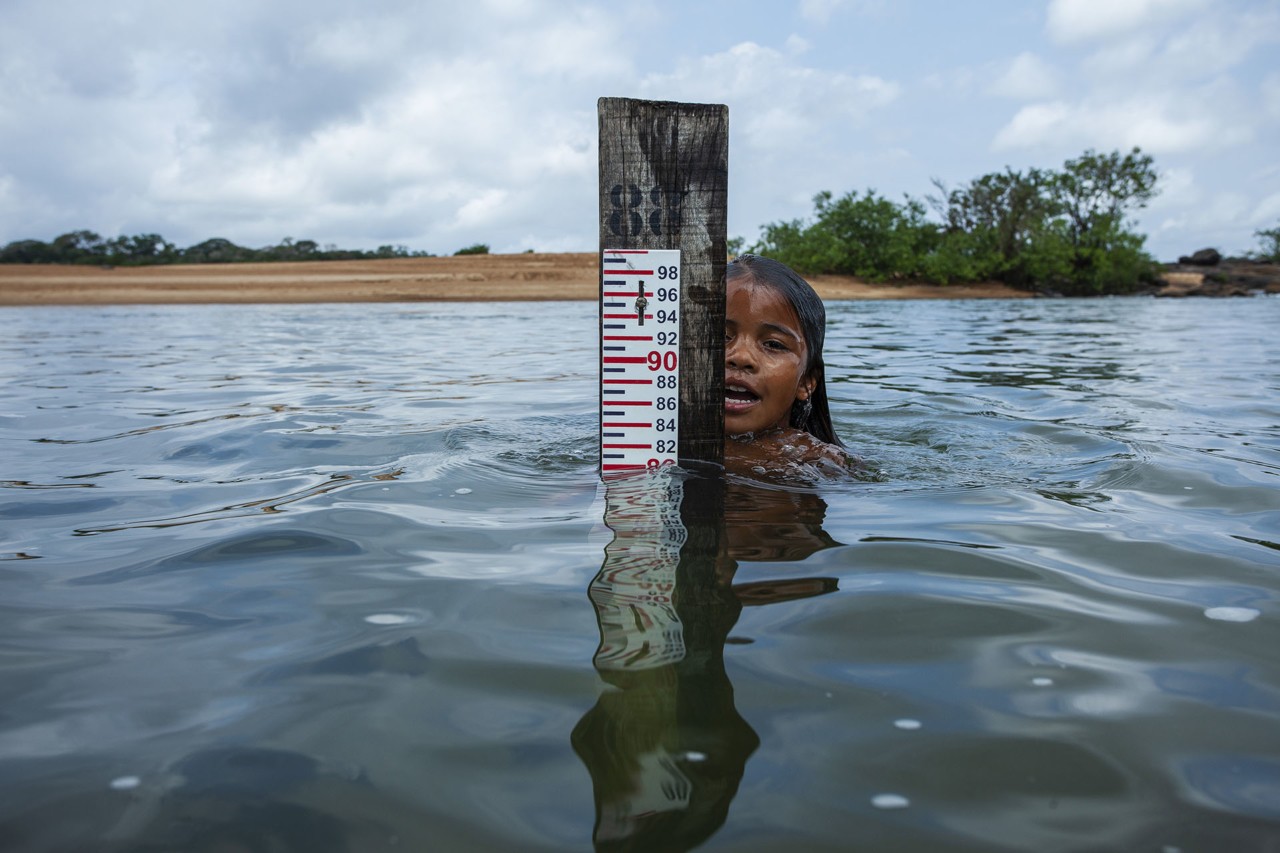 Child swimming in Xingu River by Lalo de Almeida