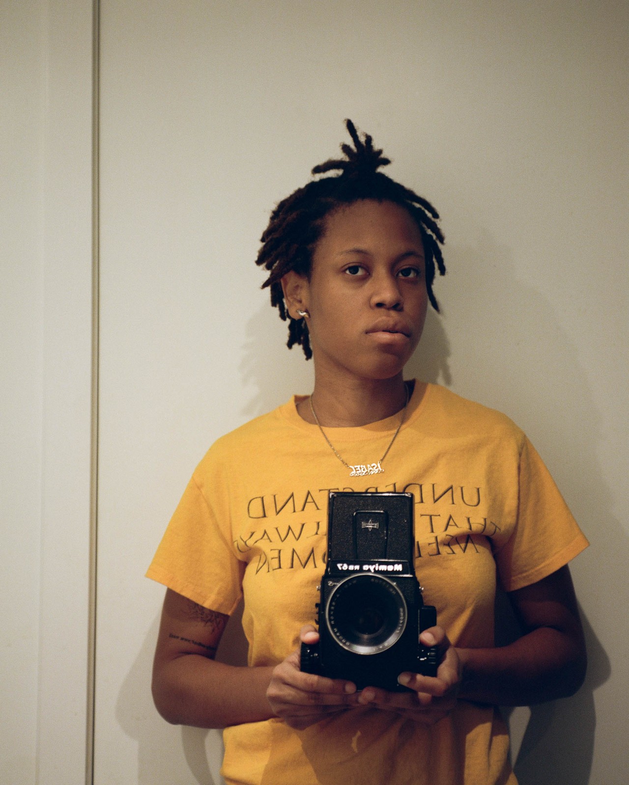 Isabel Okoro holding a camera