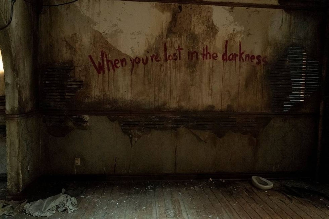 An image from the season premiere of The Last of Us shows a wall painted with red words that read, 
