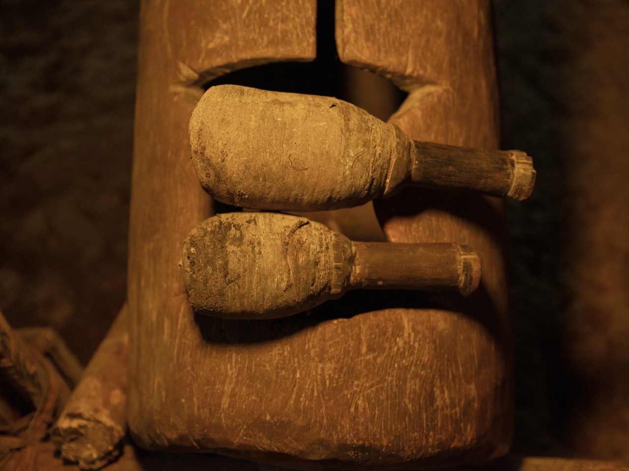 An upclose shot of a large drum and two home-made drum sticks in the Amazon rainforest.