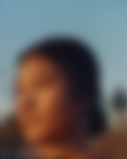 A young woman looks away from the camera.