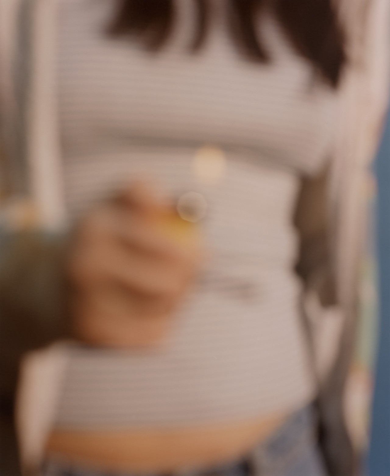 Blurry mid-section of a teenager using a lighter in one hand
