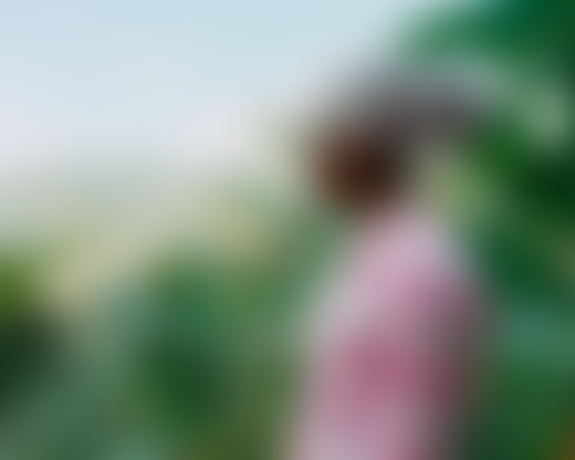 The profile of a Jamaican woman is shown as she looks toward the Blue Mountains of Jamaica.