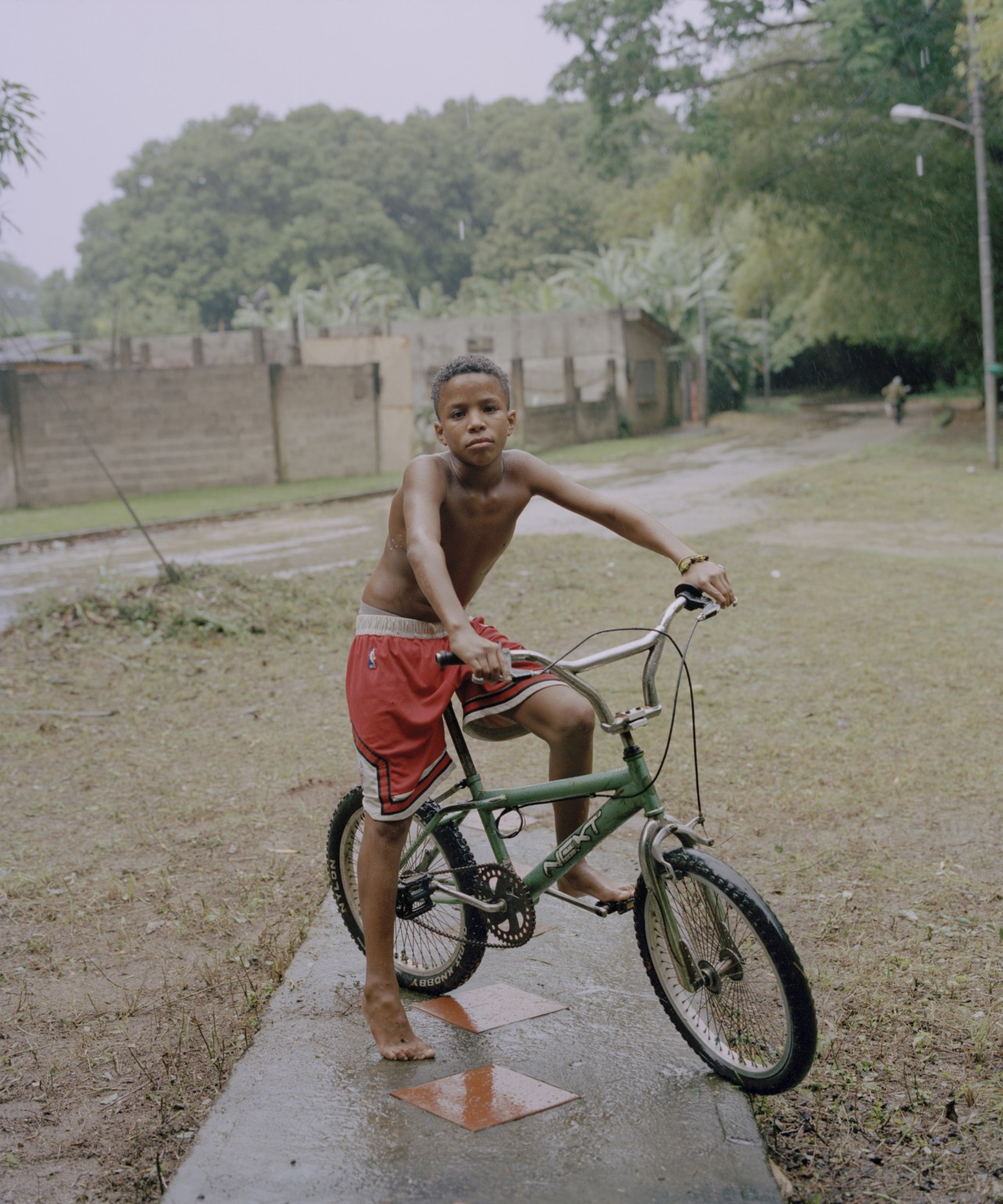 A young boy from Venezuela poses on his bike.