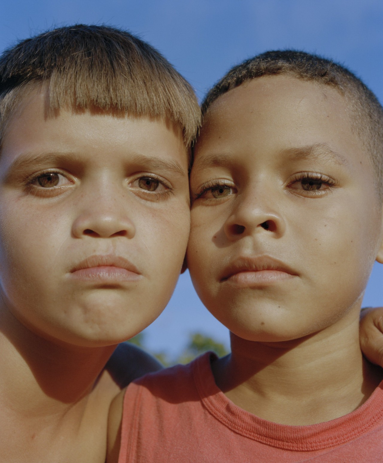 Two young Venezuelan boys stare into the camera.