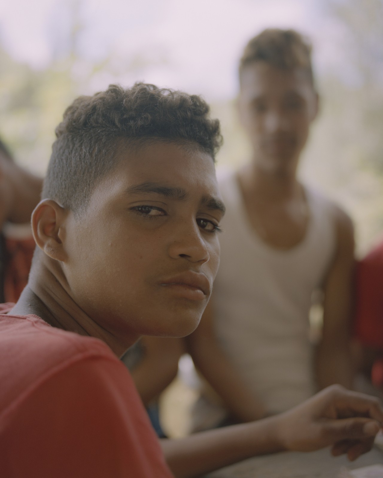 A young man from Venezuela looks back at the camera.