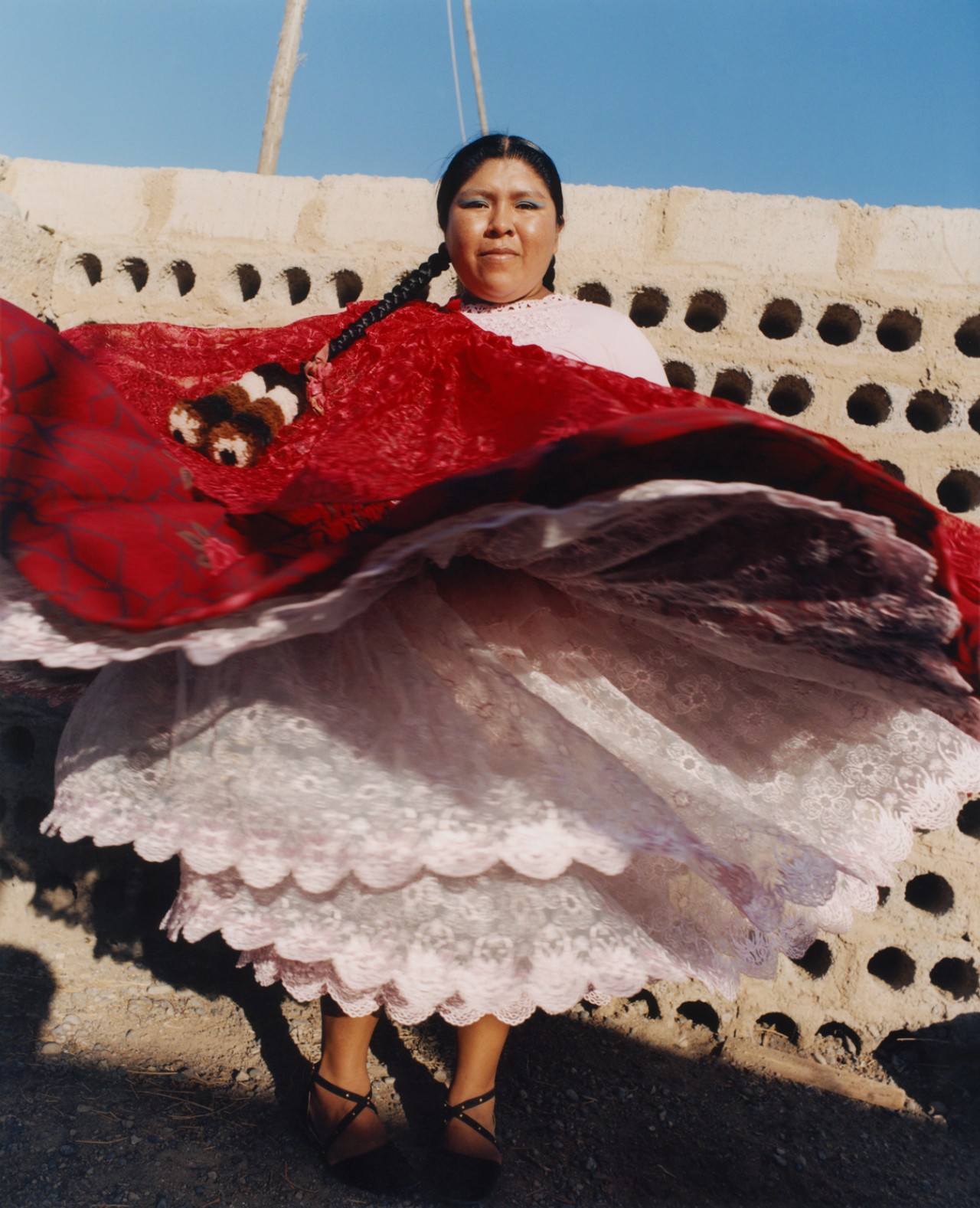 Lourdes Gutiérrez dancing, wearing her vibrant red polleras.