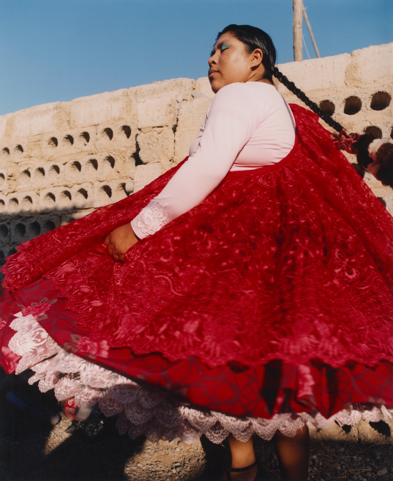 Lourdes Gutiérrez dancing, wearing her vibrant red polleras.