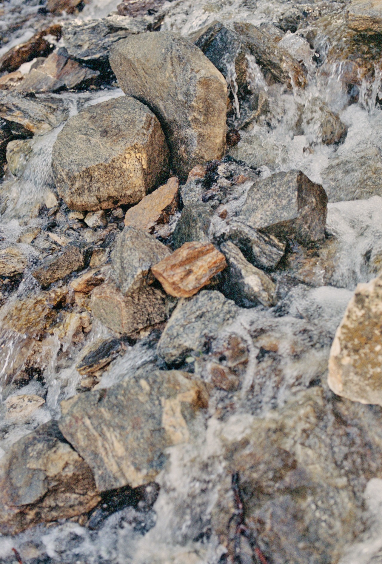 Running water flows through a medley of rocks.