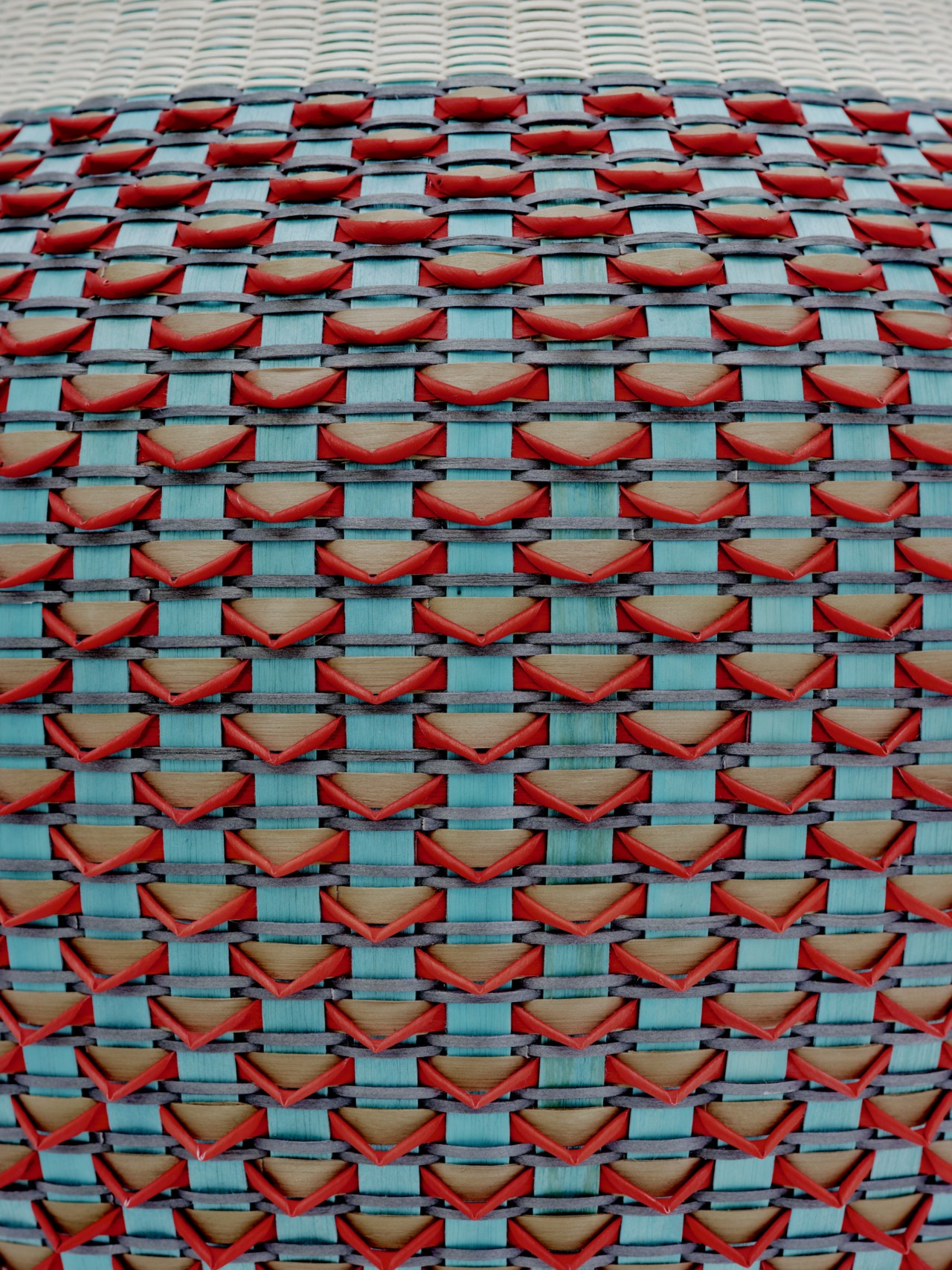A close up shot of a red and blue patterned basket.
